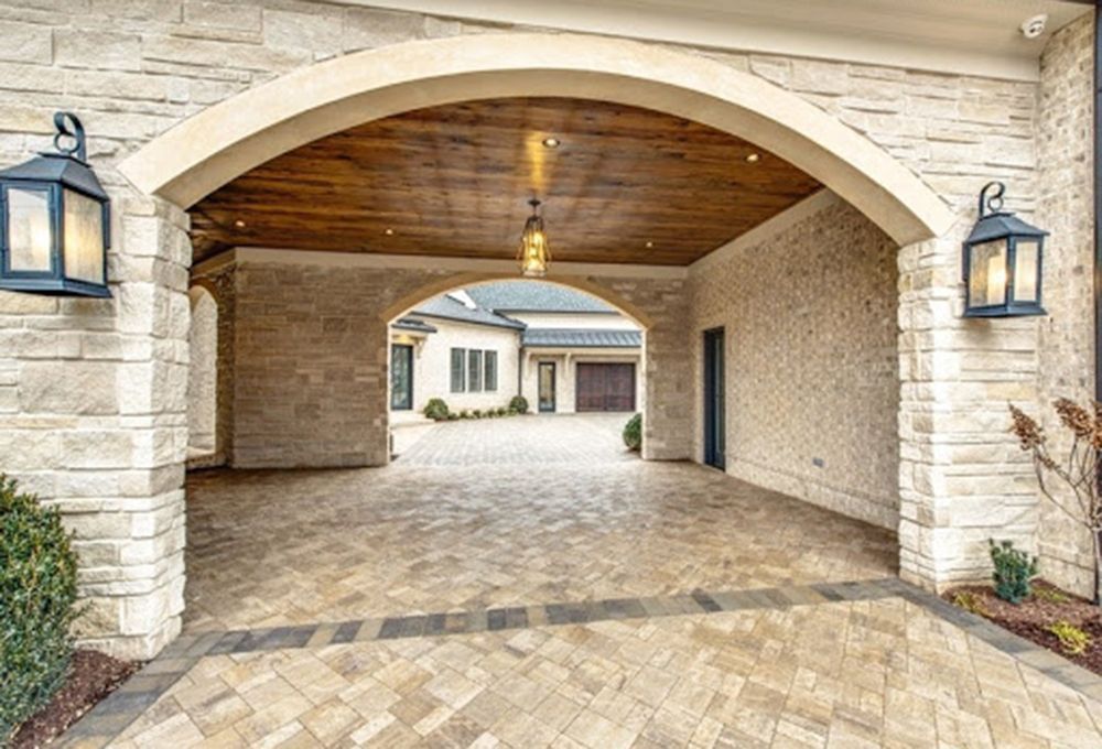 Custom lights lining the entryway of a stone garage