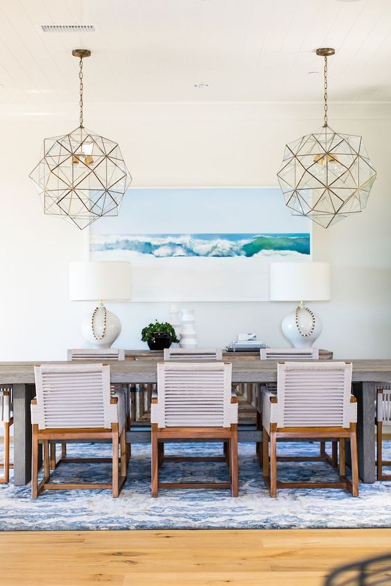 Geometric gold lighting hanging over dining table