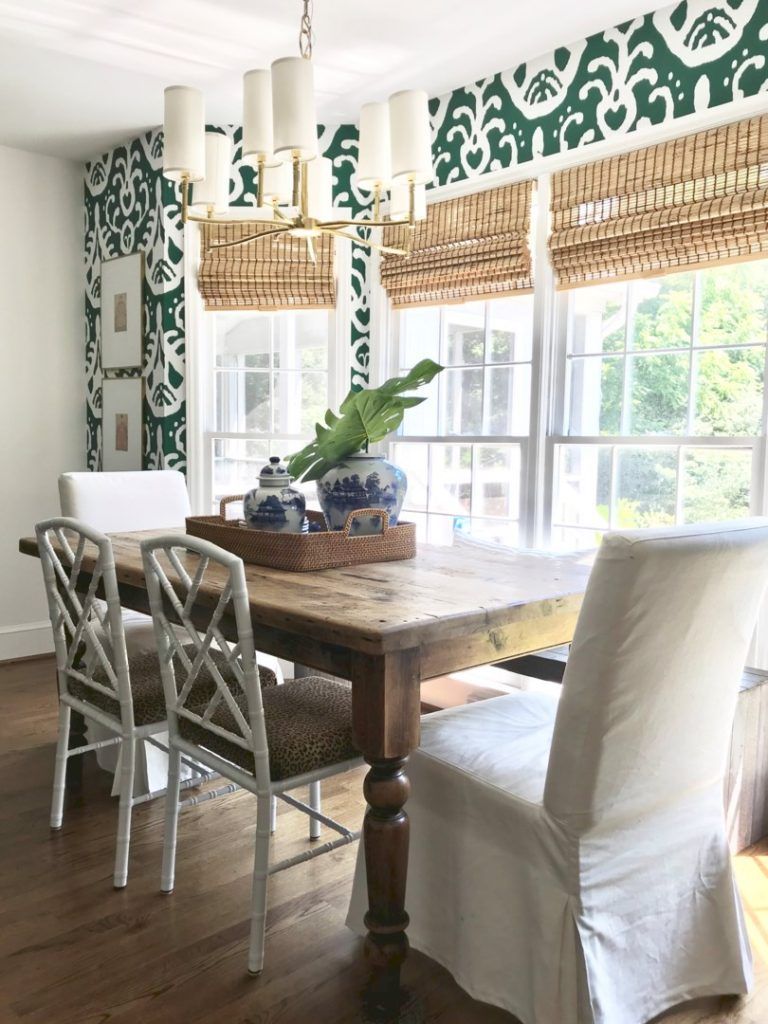 Gold and white chandelier hanging over dining table