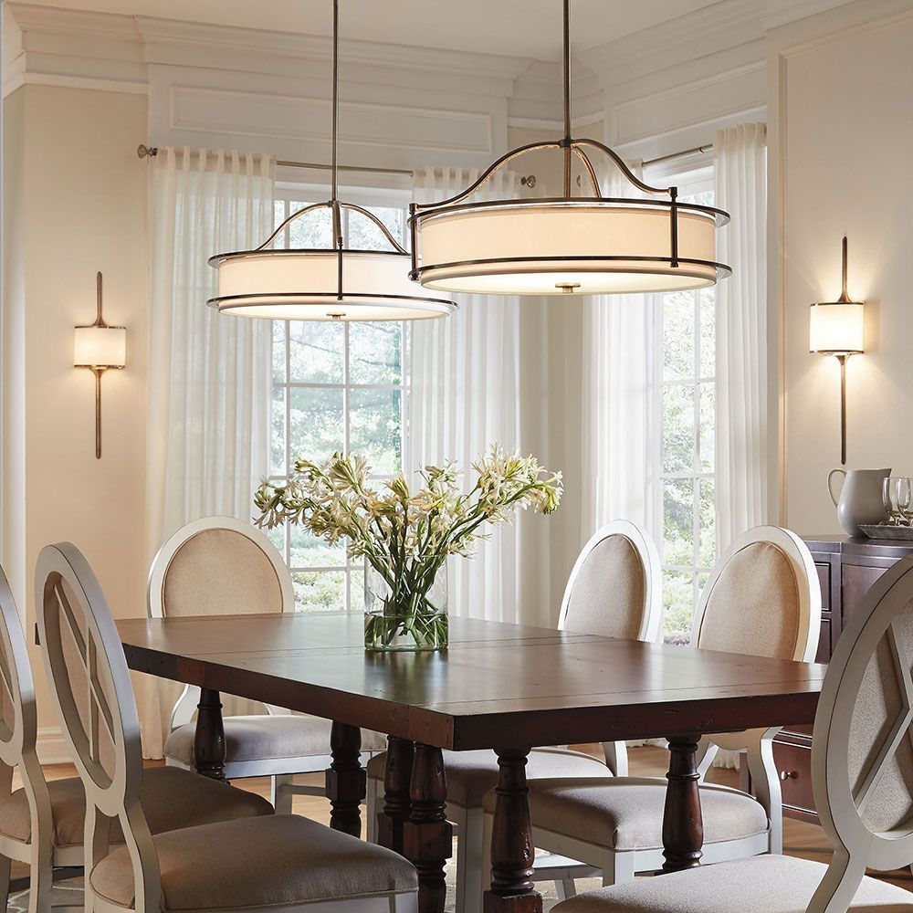 Circular lighting hanging over dining table