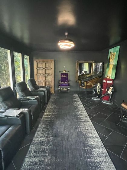 An empty room with hardwood floors and a ceiling fan.