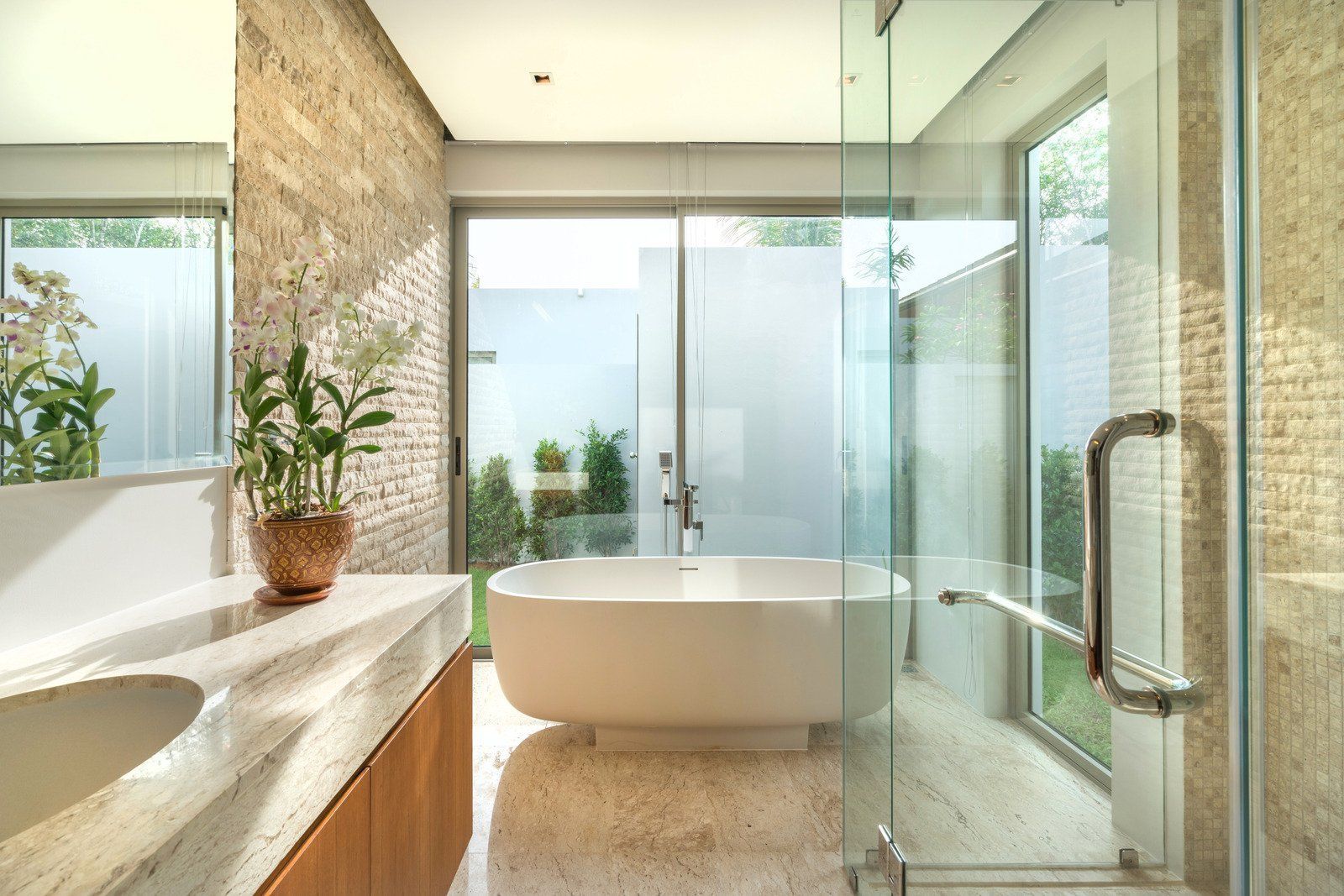 A bathroom with a bathtub , sink , and shower.