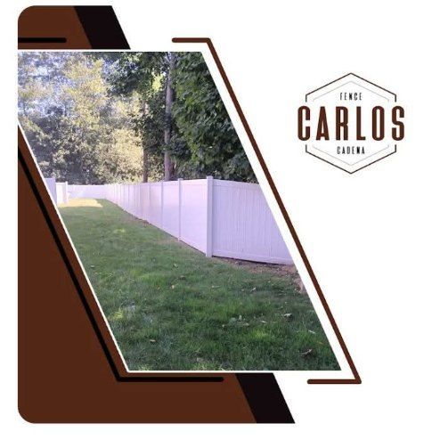 White fence along a grassy yard with trees in the background. Brown logo in the corner.