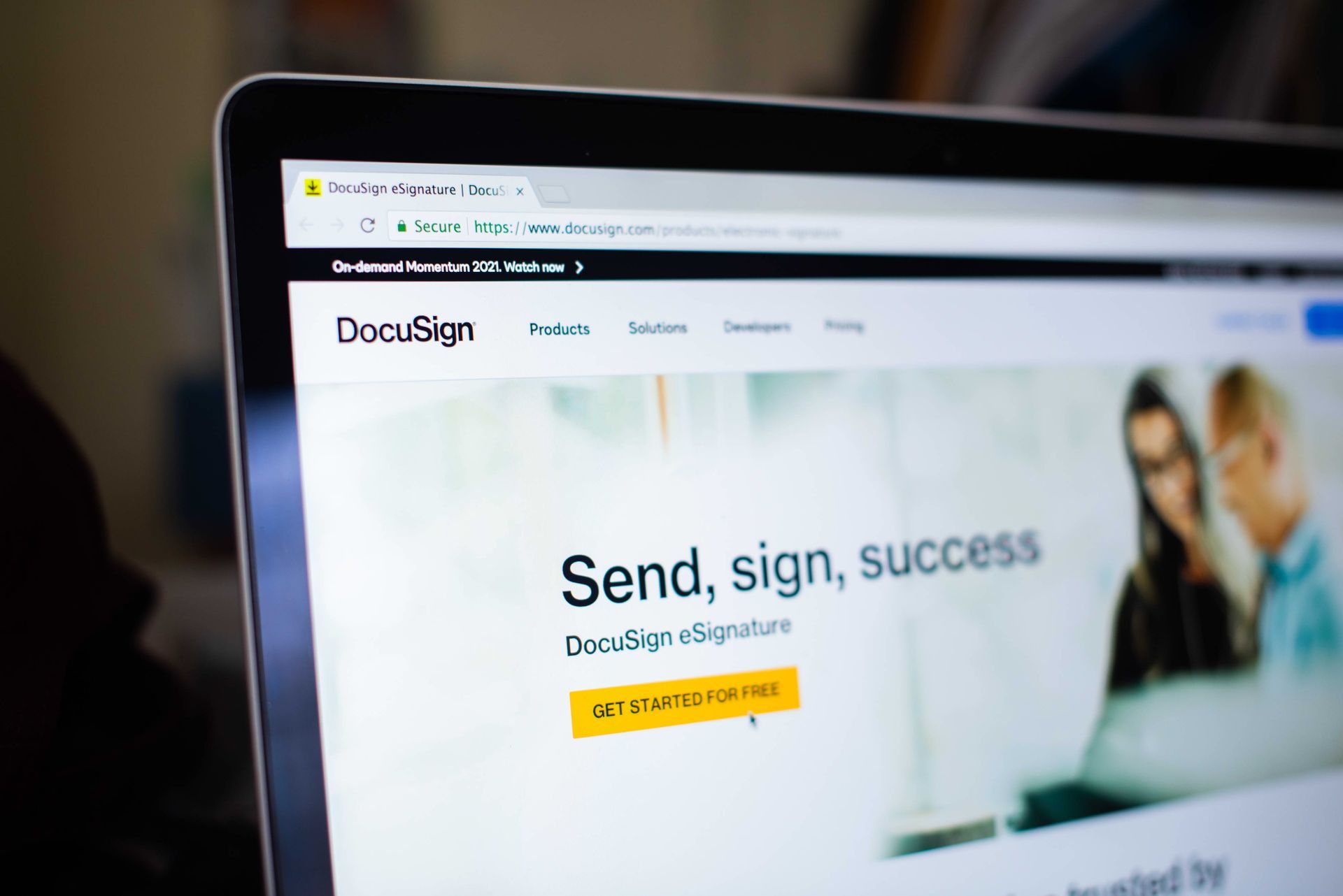 A laptop computer is open to a website that says send , sign , success.