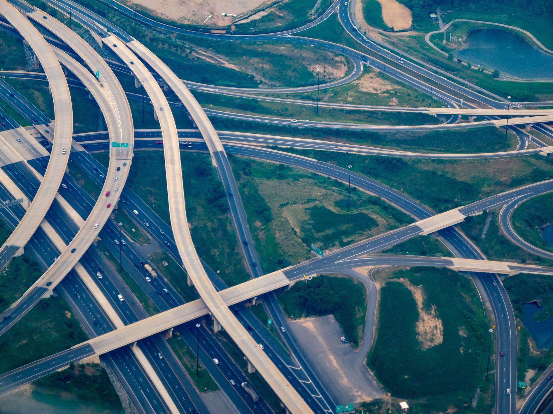An aerial view of a highway intersection with a lot of traffic