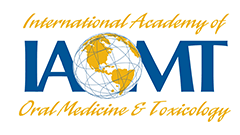Logo for the International Academy of Oral Medicine & Toxicology, with blue IAIOMT letters and a gold globe