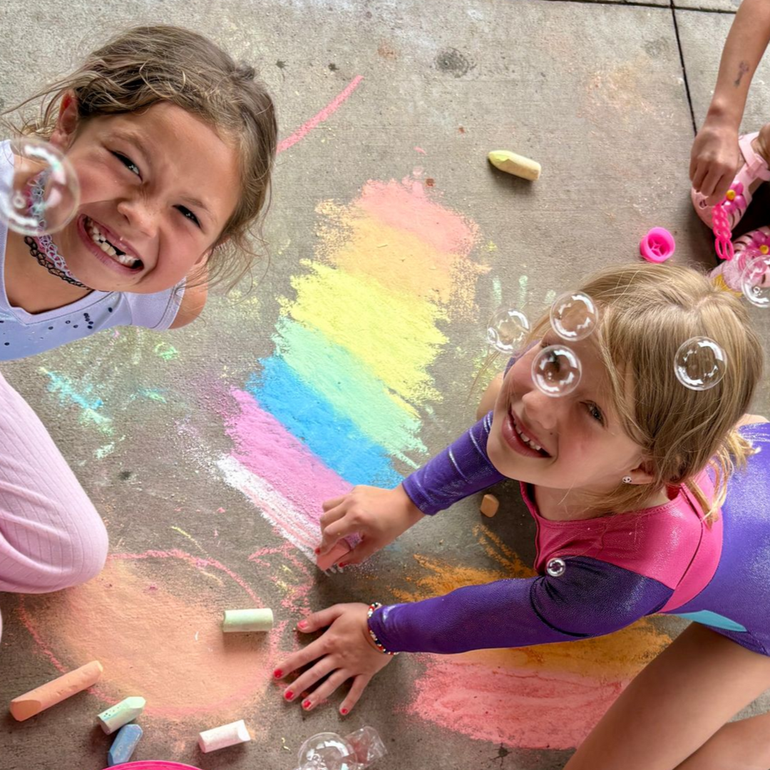 Camp Balance students decorating the front patio with chalk