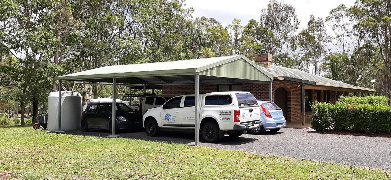 Sturdy Steel Carport Frame With Cars Underneath — Shed Kits in Lismore, NSW