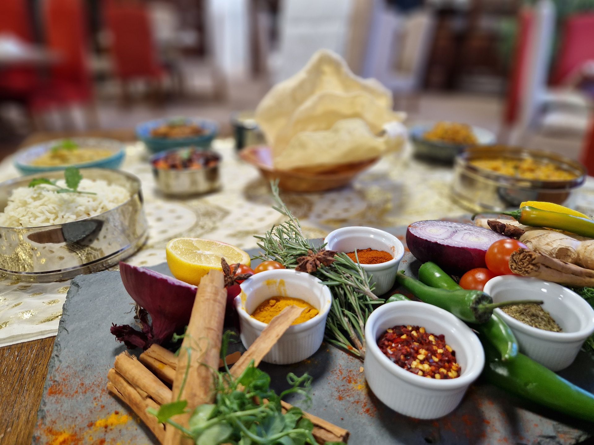 Pan‑Asian herbs, spices and fresh ingredients, alongside rice and dishes, reflecting the blog’s focus on vibrant, authentic workplace Pan‑Asian cuisine.