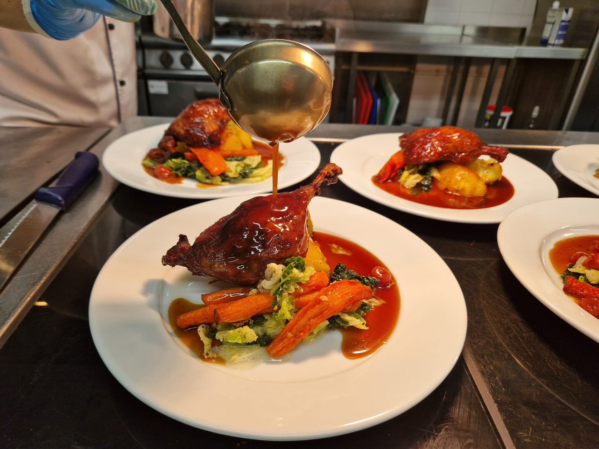 Roast duck served with vegetables and sauce being poured, showcasing balanced, nutrient‑rich meals that support wellbeing and a healthy stress response.