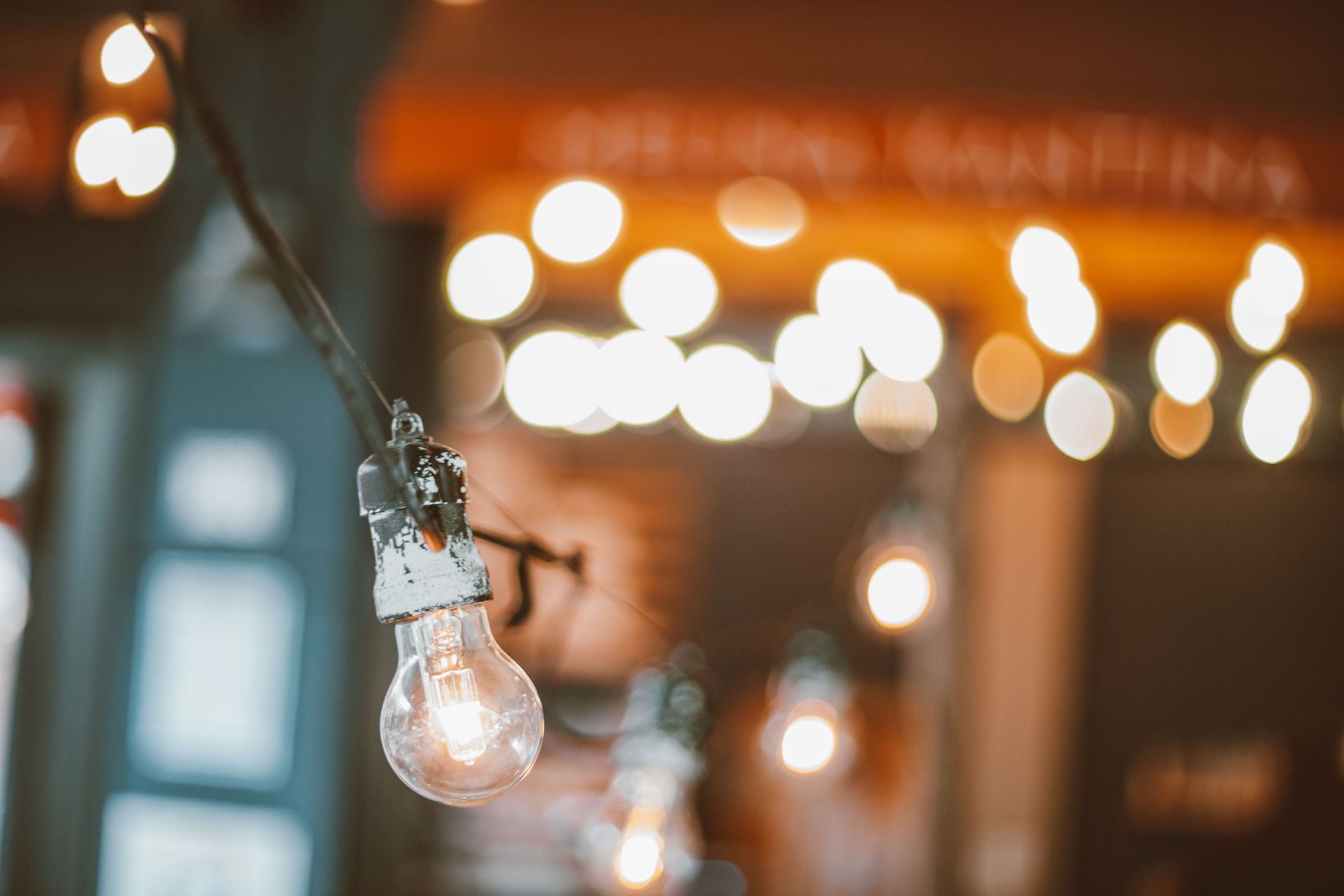 Warm hanging bulb lights with soft blurred bokeh in a cozy indoor setting