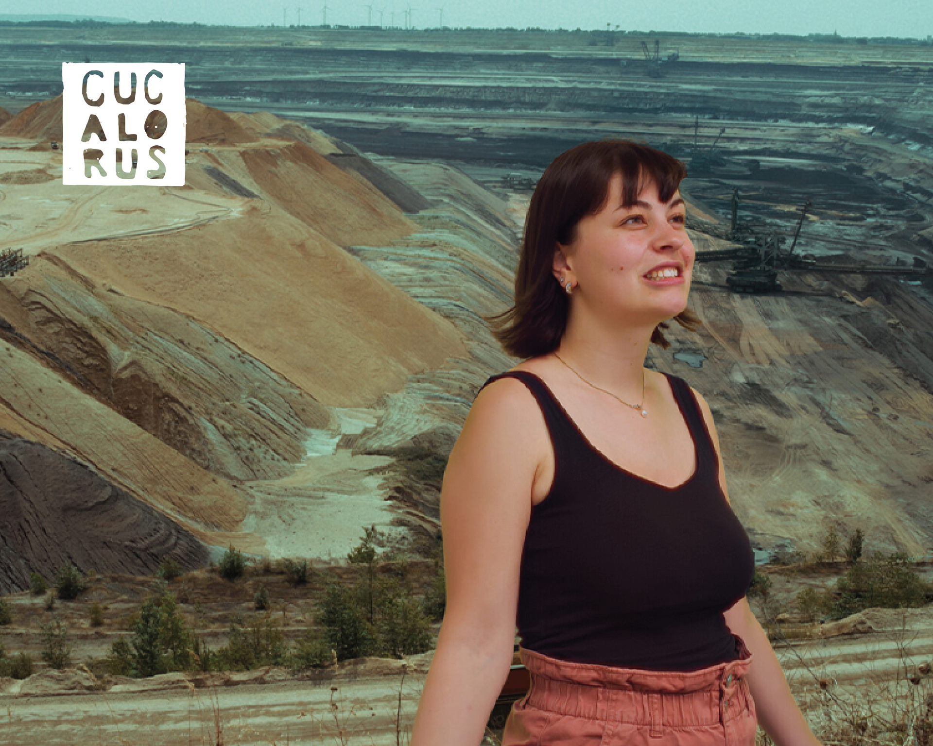 Woman in a black tank top standing before layered sand cliffs under a cloudy sky