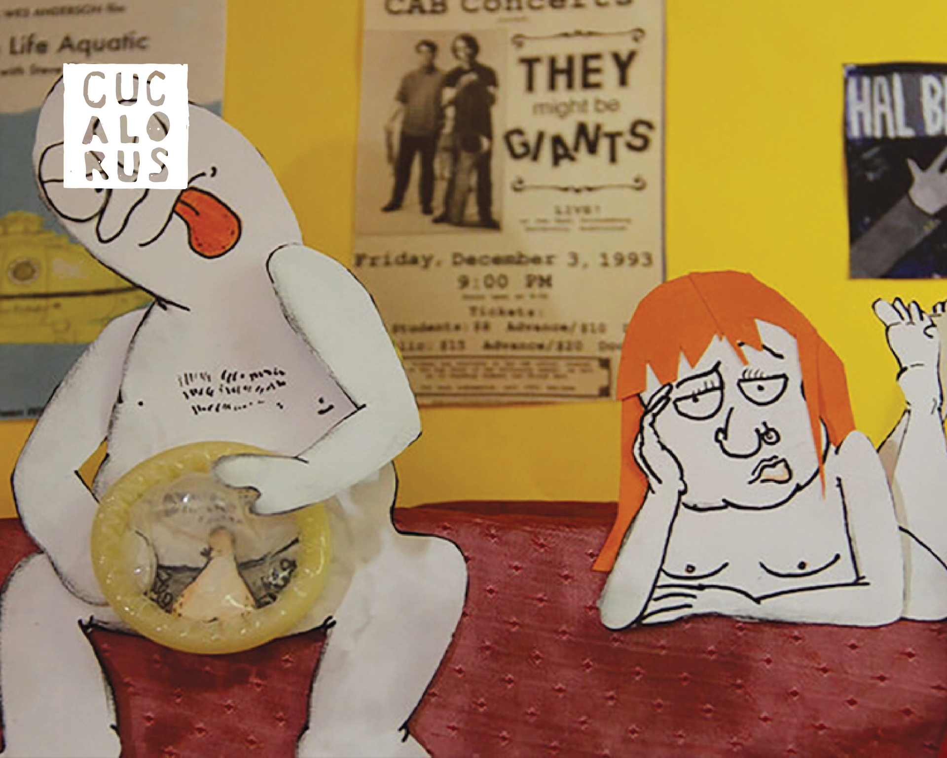 Paper cutout figures in a collage, one white and one orange-haired, against a poster-covered background