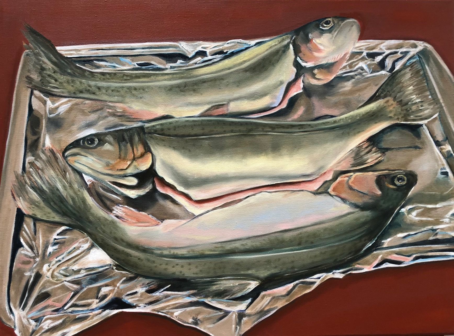 Three fish on a patterned cloth, painted in muted silver, tan, and pink tones.