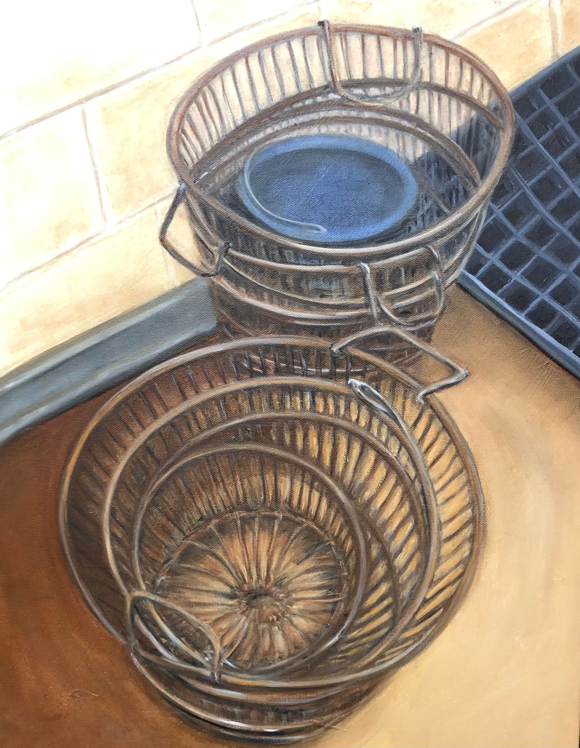 Stacked wire baskets in a corner, with a blue dish in the top basket.