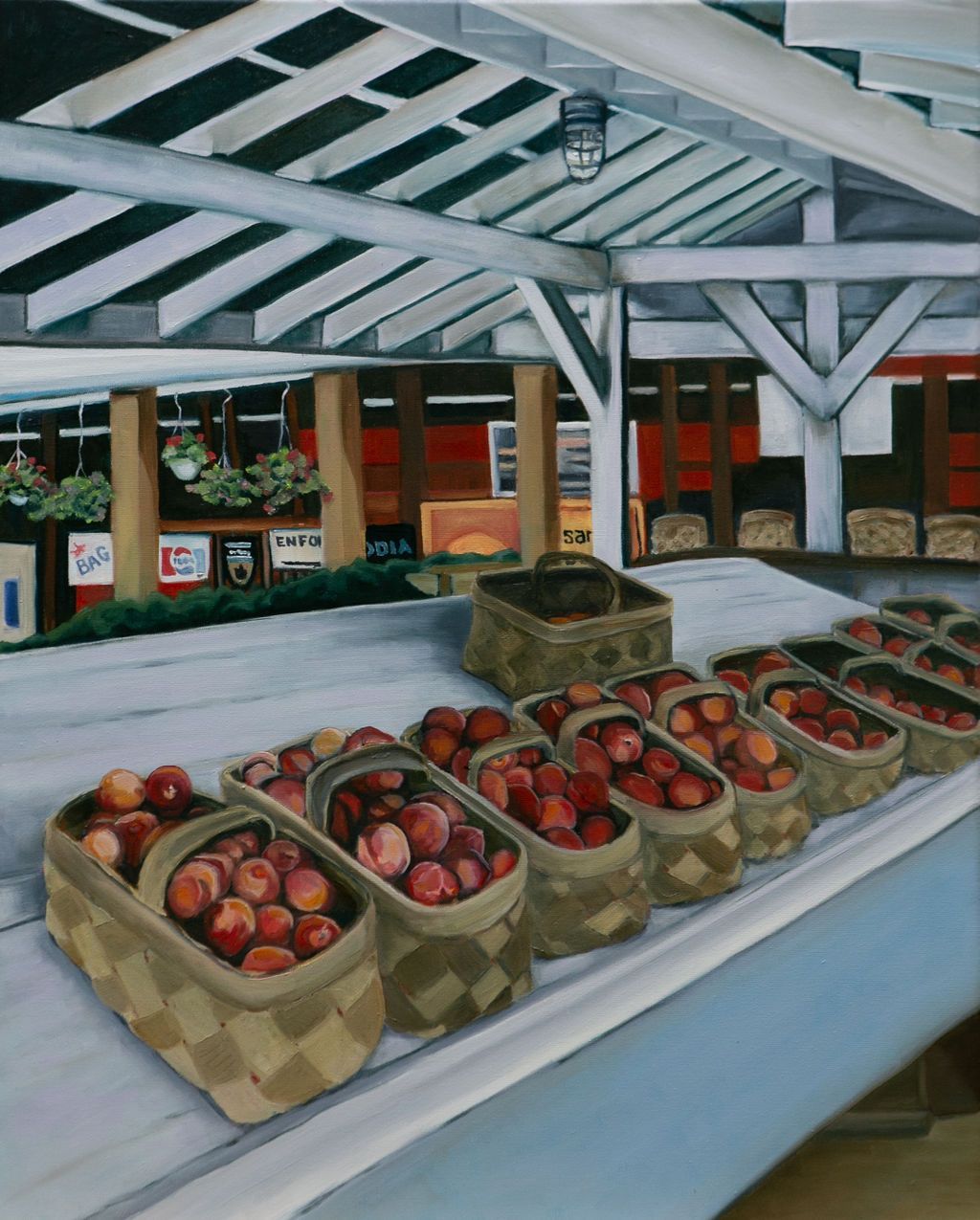 Baskets of red apples displayed on a market counter under a white pavilion roof.
