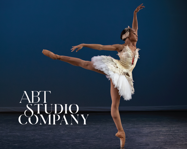 Ballet dancer in white tutu leaping on stage beside the text “ABT STUDIO COMPANY”