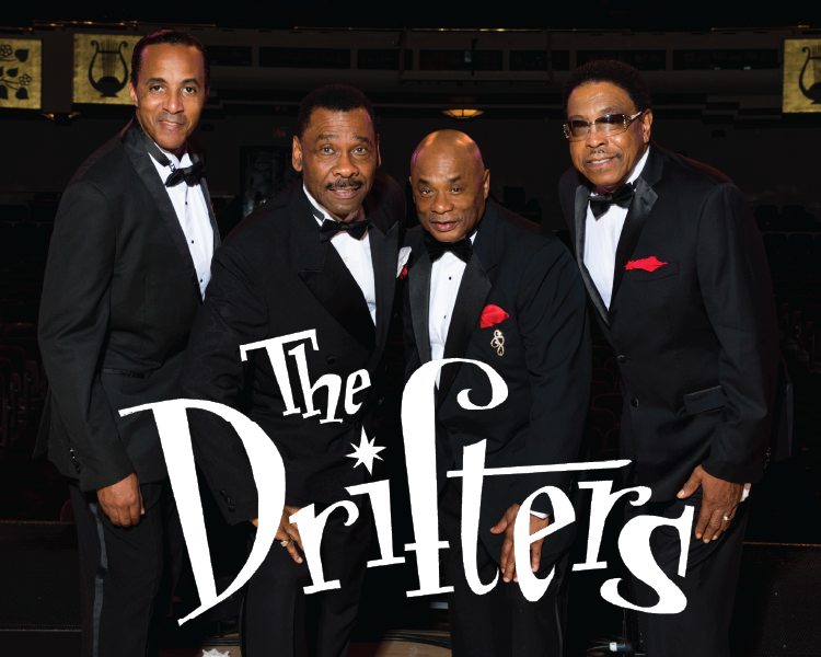 The Drifters in tuxedos posing against a dark background