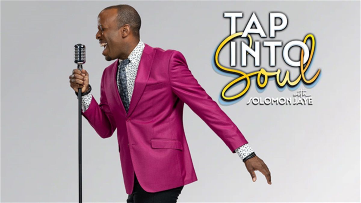 Singer in a bright pink blazer singing into a microphone beside the “Tap Into Soul” logo.