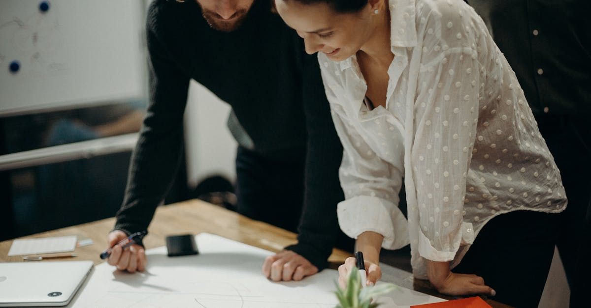 Two people working together, standing over a desk. Legal career tips, resources and FAQ's