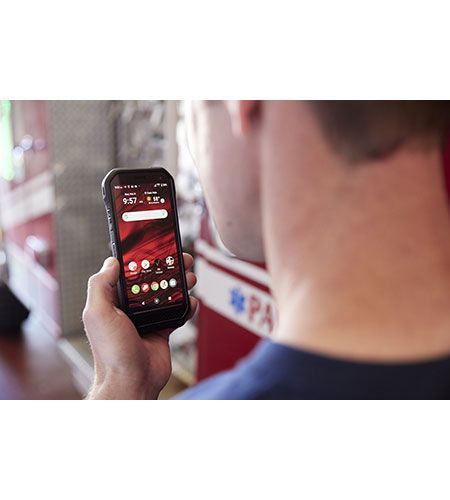A man is holding a cell phone in his hand.