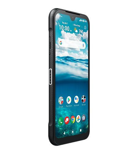 A black cell phone with a blue screen is sitting on a white surface.