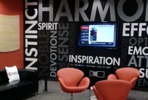 Two red chairs in front of a wall that says 
