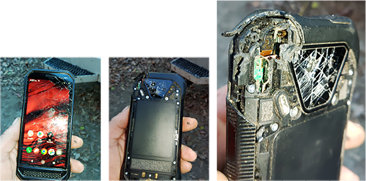 A person is holding a broken cell phone in their hand.