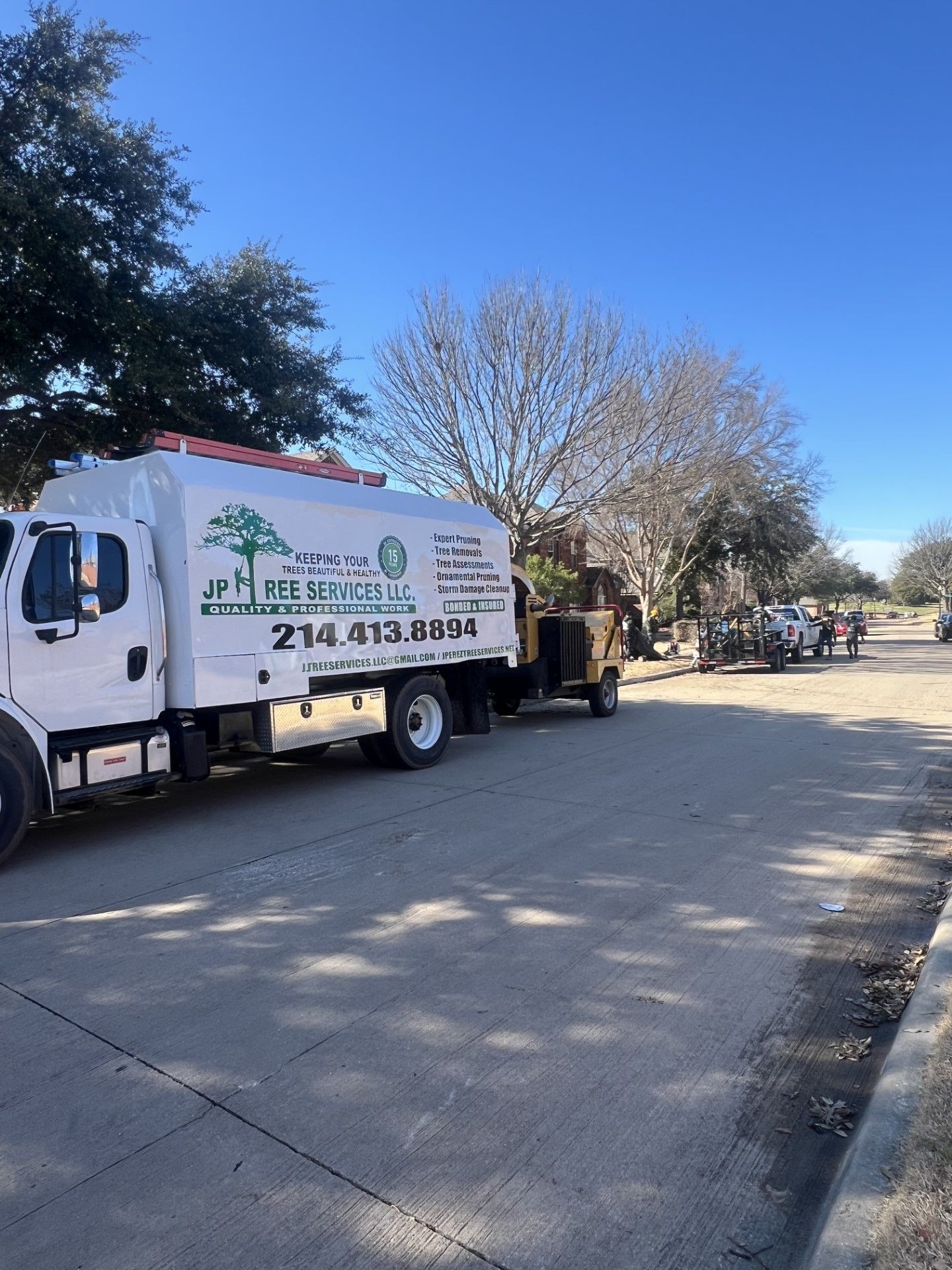 A white truck is parked on the side of the road.