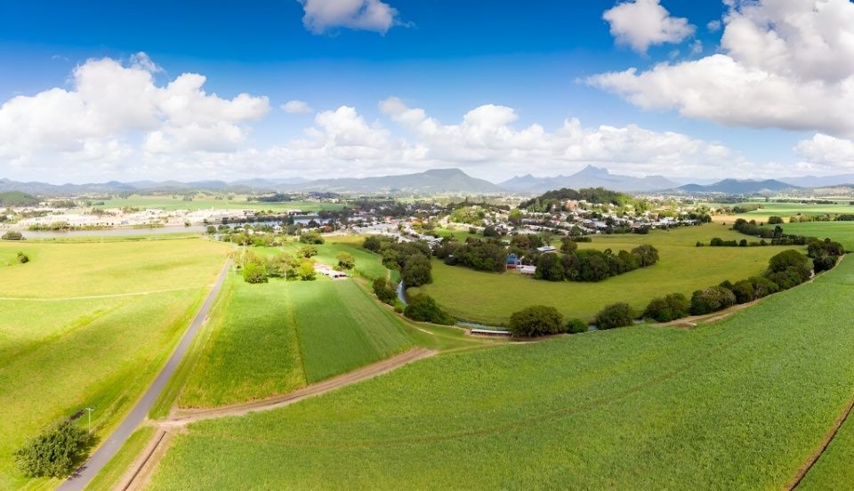 An Aerial View of a Lush Green Field With a Road Going Through It — Taree Tilt Tray Towing In Wootton, NSW
