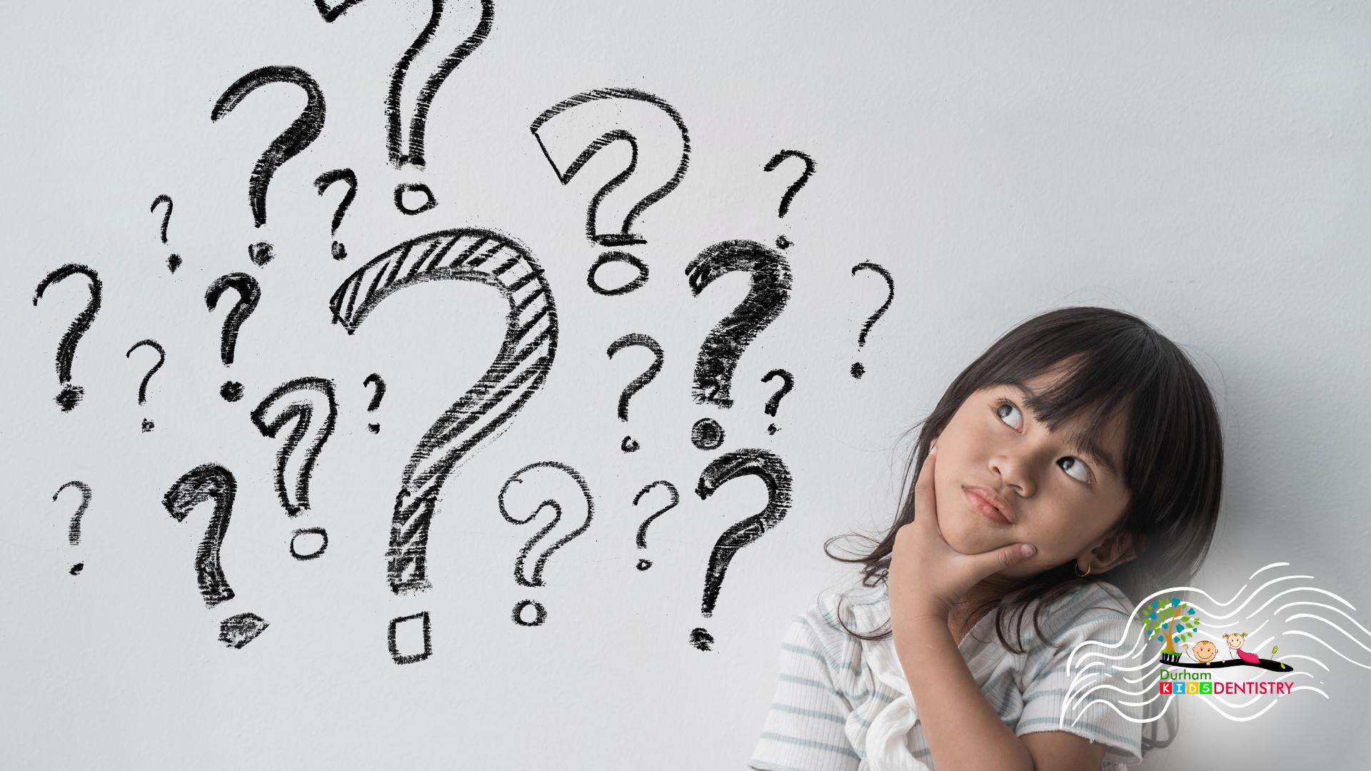 Person sitting beside a wall of question marks, looking thoughtful and puzzled.