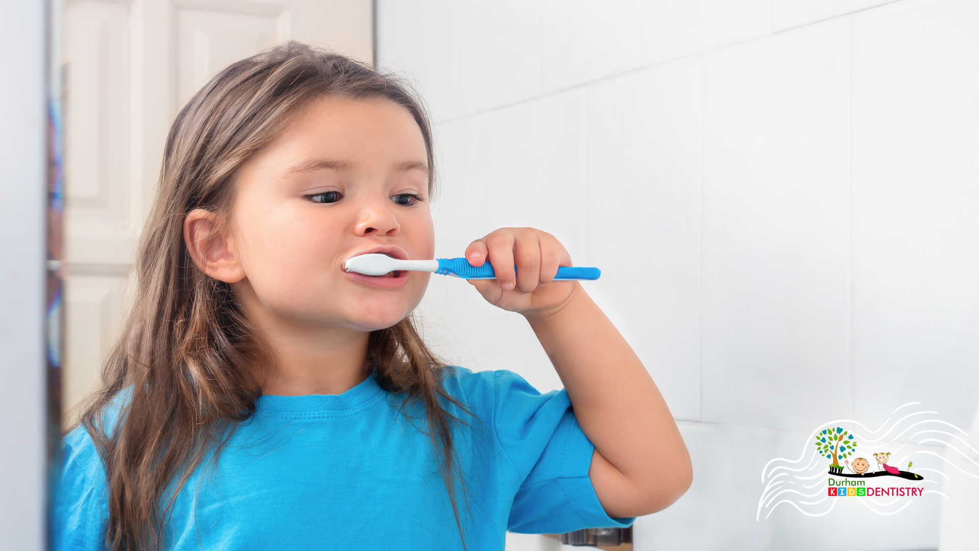 Child brushing teeth with a blue toothbrush in a bathroom