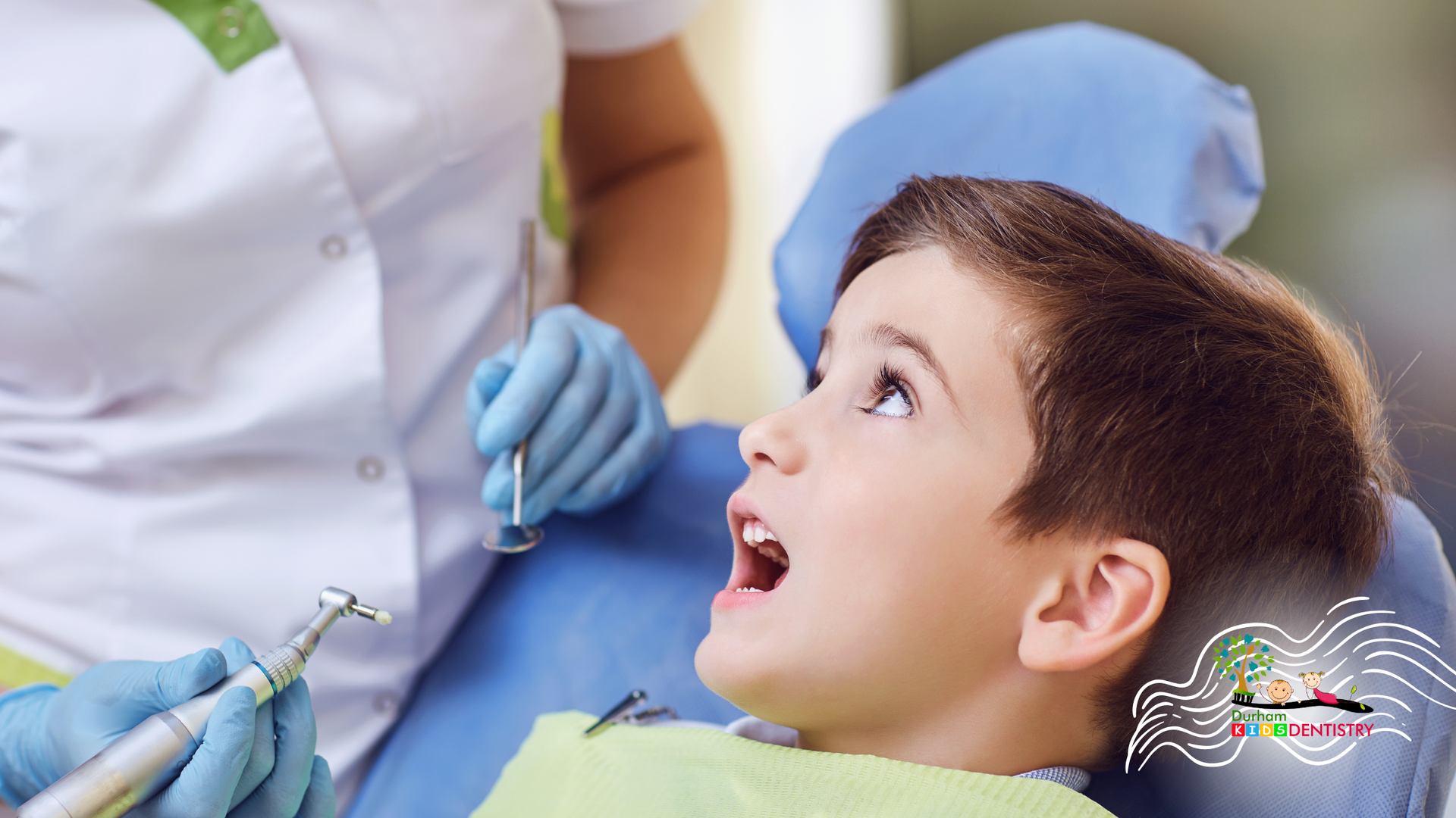 Dentist preparing a child patient for treatment in a dental chair, with gloved hands and tools visible.