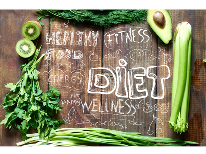 Fresh vegetables and fruits arranged on a wooden table with chalk-style words like 