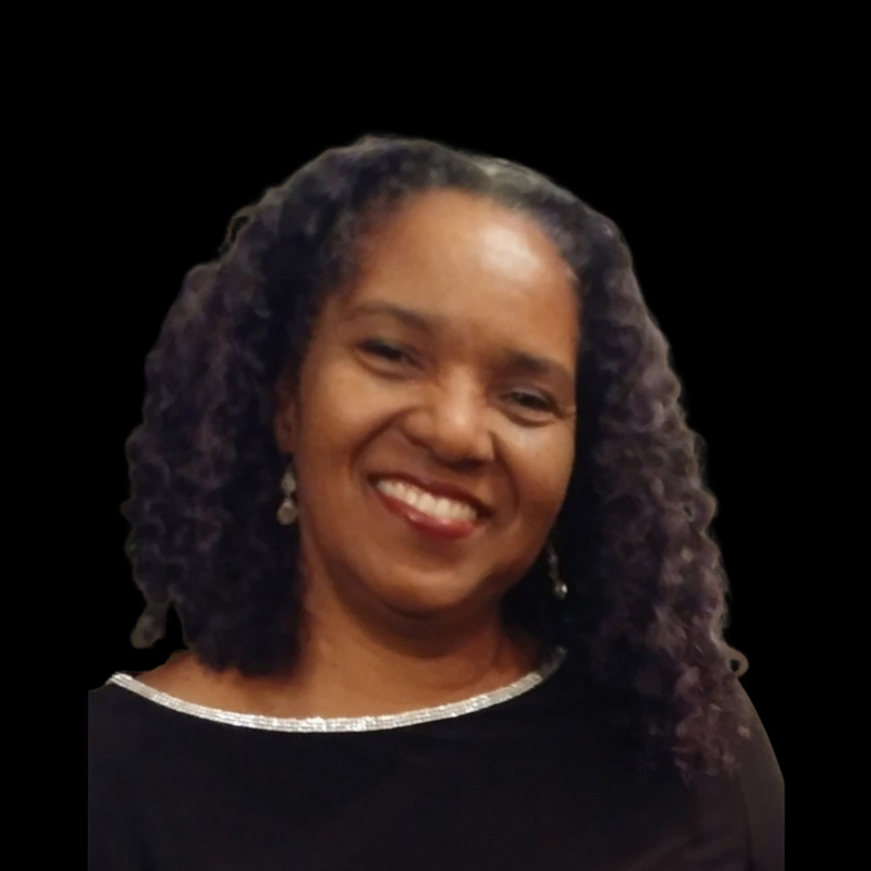 Sherri a board member A smiling person with dark, wavy hair and dangling earrings, wearing a black top with a silver-trimmed neckline.