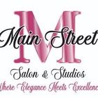 Logo for Main Street Salon & Studios featuring a large pink "M" with cursive text reading "Where Elegance Meets Excellence."