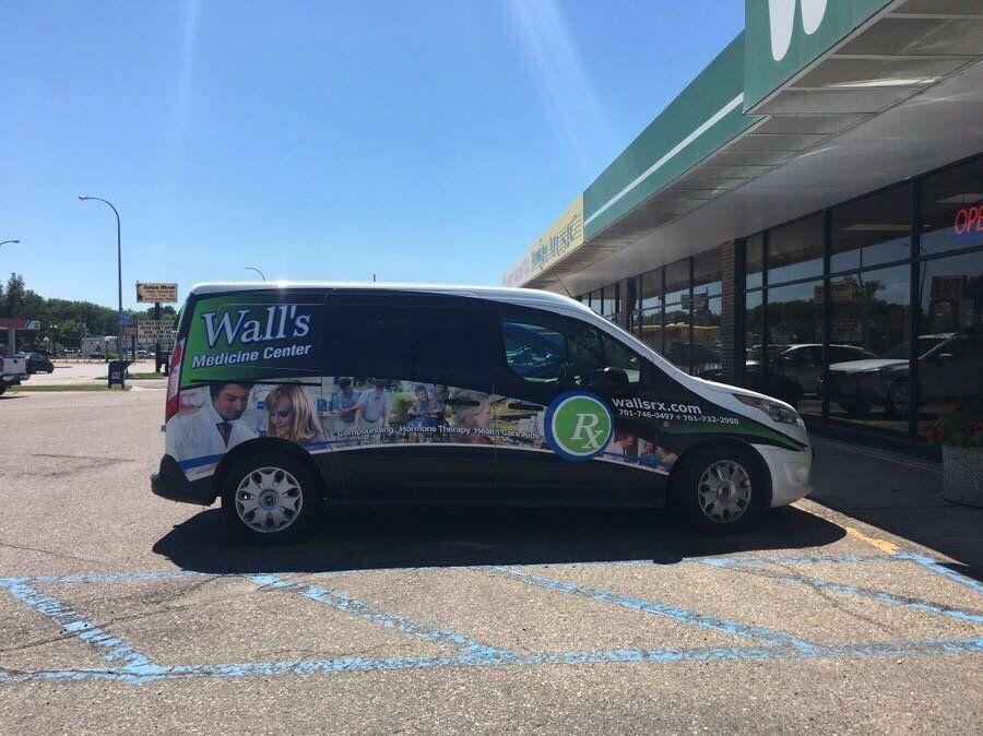A Wall's Medicine Center van parked in front of our store on a sunny day.