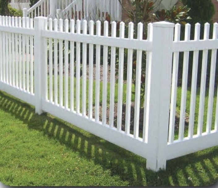 White picket fence on green grass.