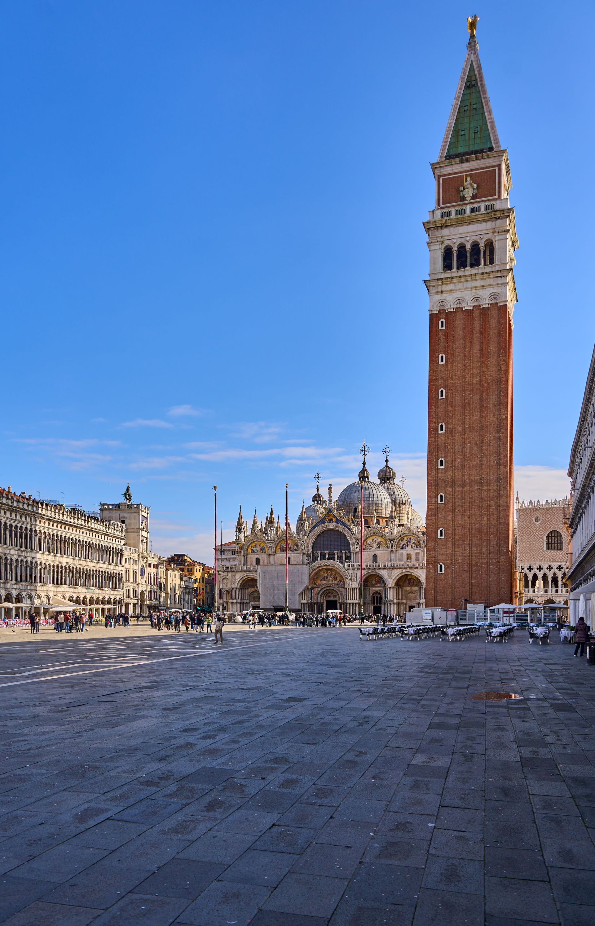 St. Mark’s Campanile and Basilica in Venice’s Piazza San Marco under a clear blue sky
