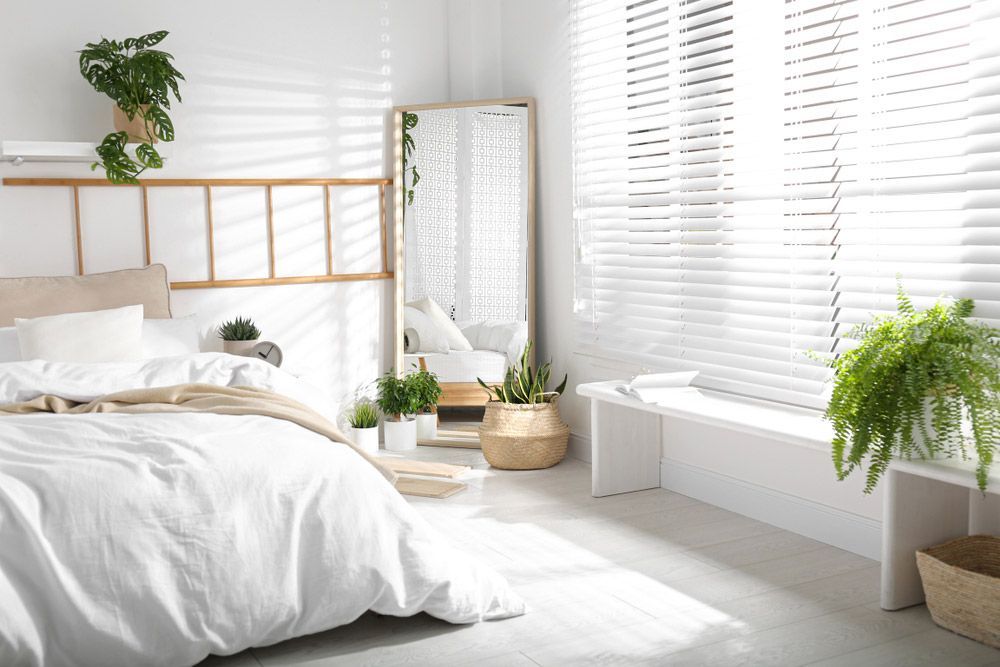 Modern Bedroom Interior with Stylish Large Mirror — Window Furnishing Services in Tallebudgera, NSW