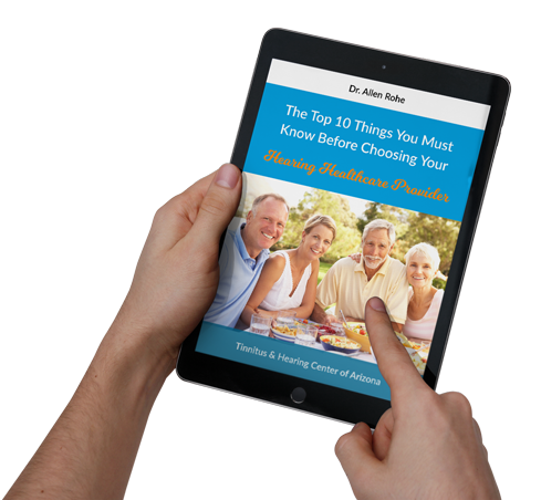 Hands holding a tablet displaying a blue ebook cover about choosing a retirement community