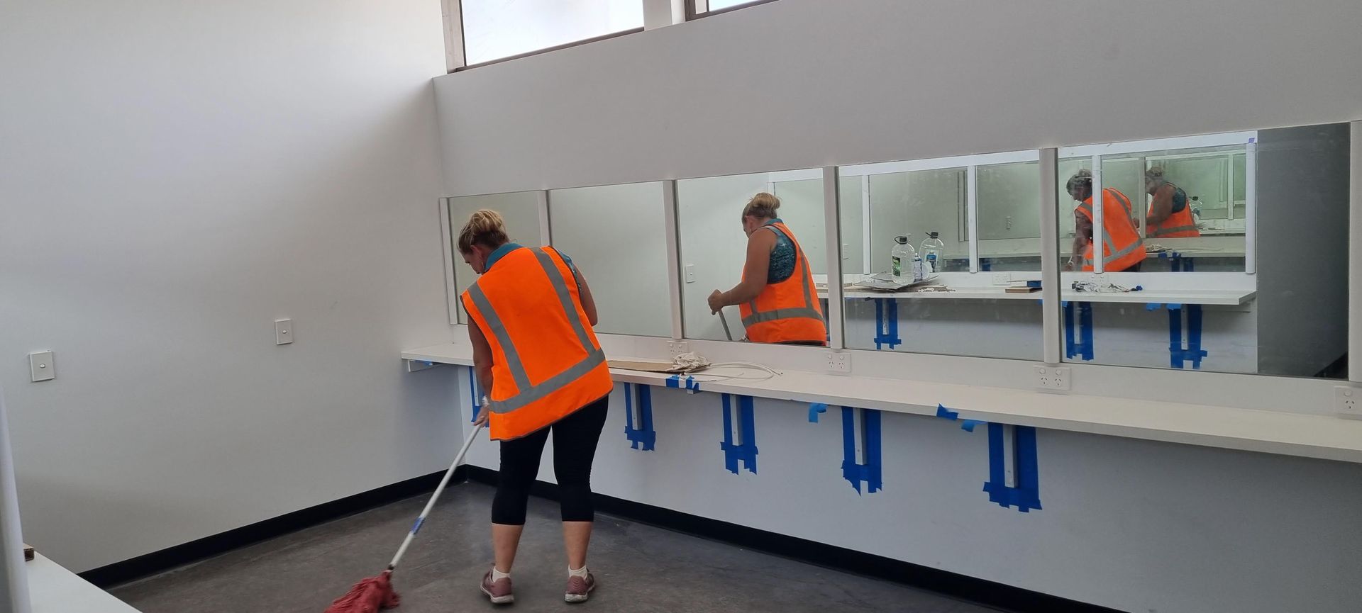 Woman cleaning construction site — Kristal Kleen Services in Airlie Beach, QLD