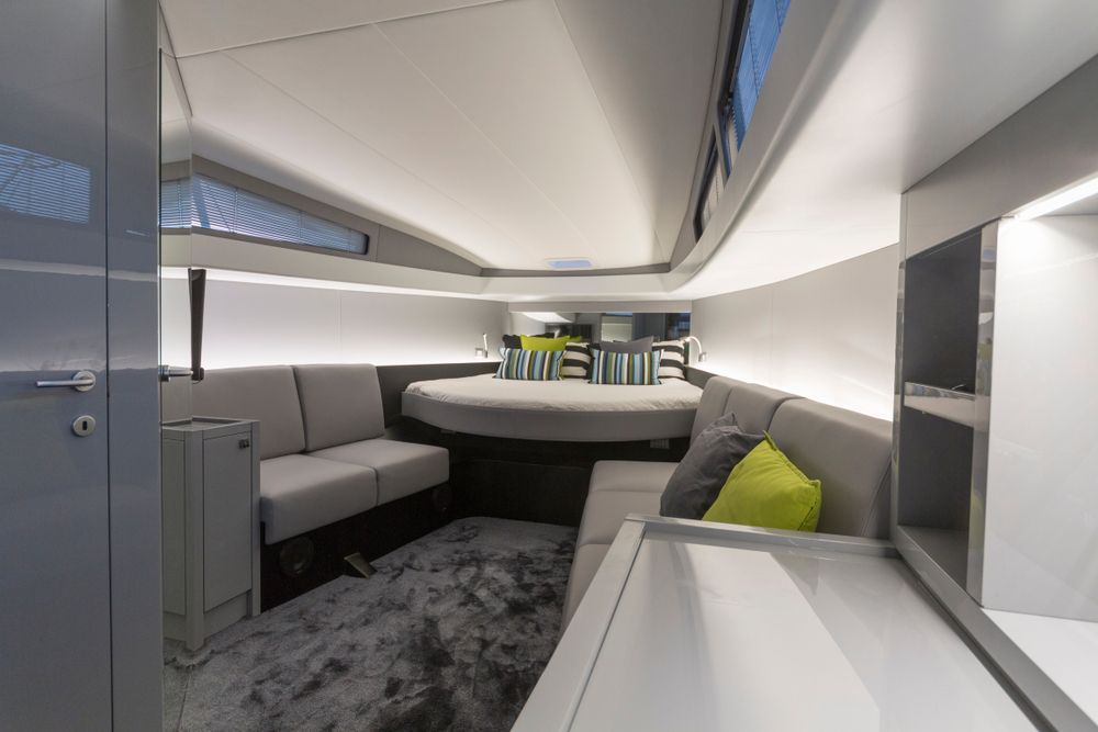 A Living Room on A Boat with A Couch and A Bed — Kristal Kleen Services in Airlie Beach, QLD