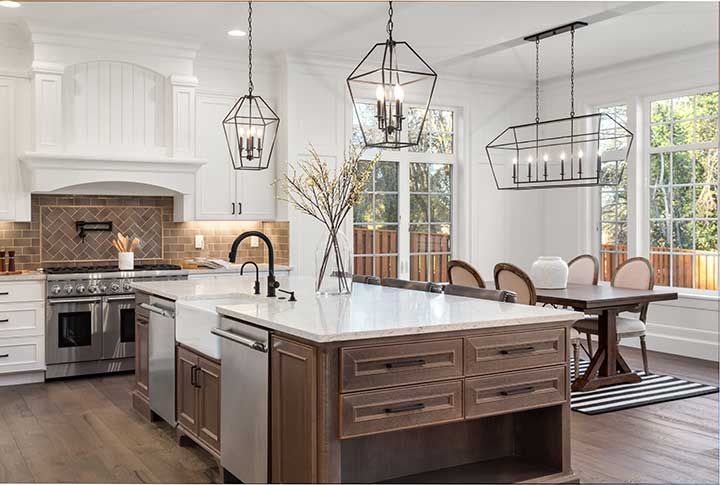 Beautiful kitchen in new traditional style luxury home, with quartz counters, hardwood floors, and stainless steel appliances