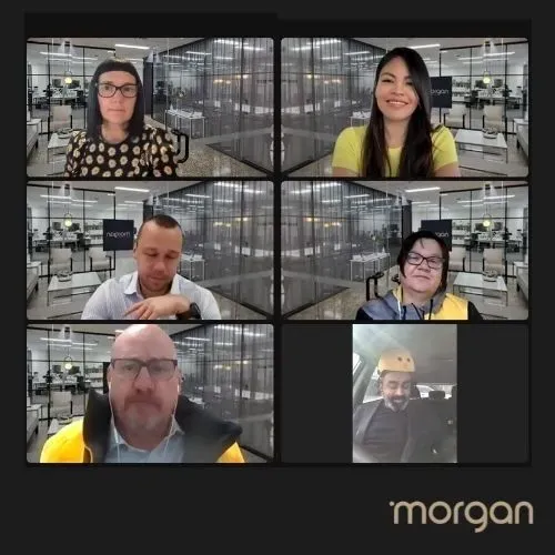 Six people in a video conference grid, each in a workspace, with the Morgan logo at bottom right.