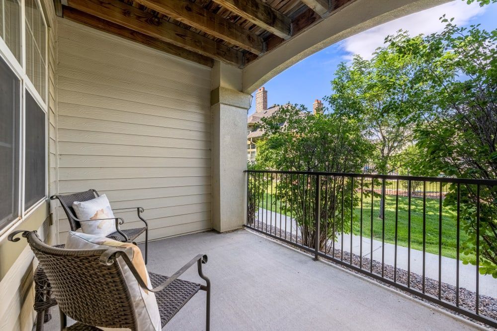 Spacious balcony with a chair and a table at Marquis at Town Centre in Broomfield, CO.