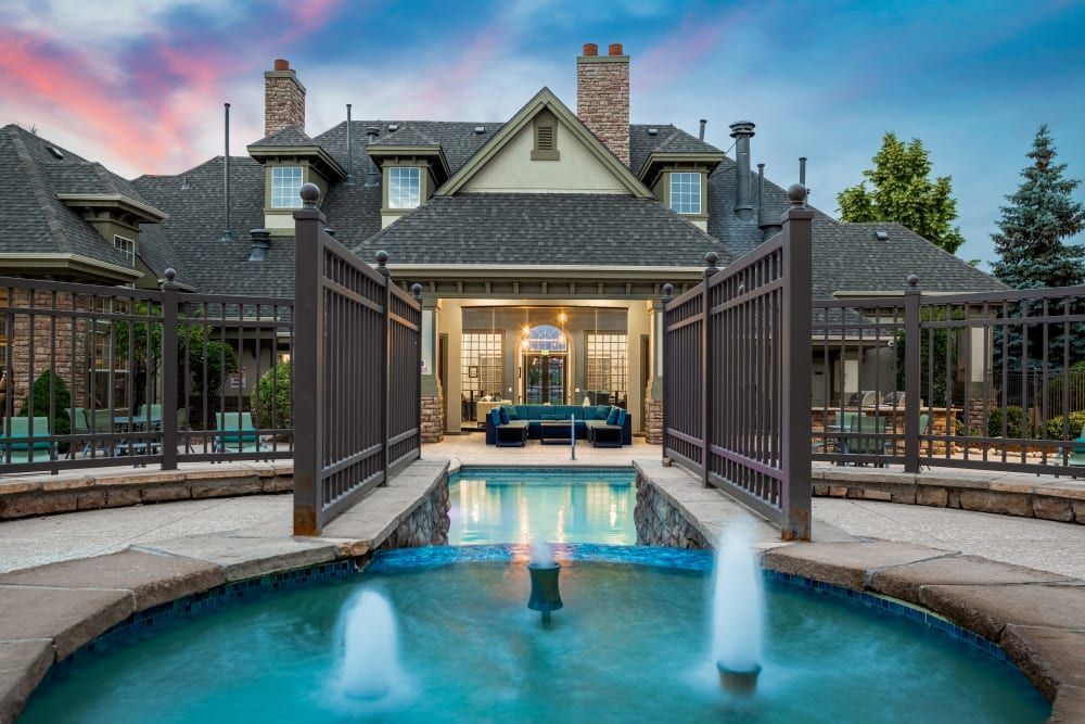 Resort-style swimming pool with a fountain at Marquis at Town Centre in Broomfield, CO.