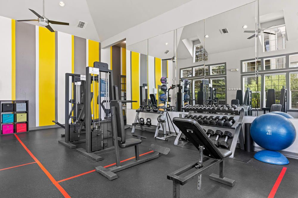 A gym filled with lots of exercise equipment at Marquis at Town Centre in Broomfield, CO.