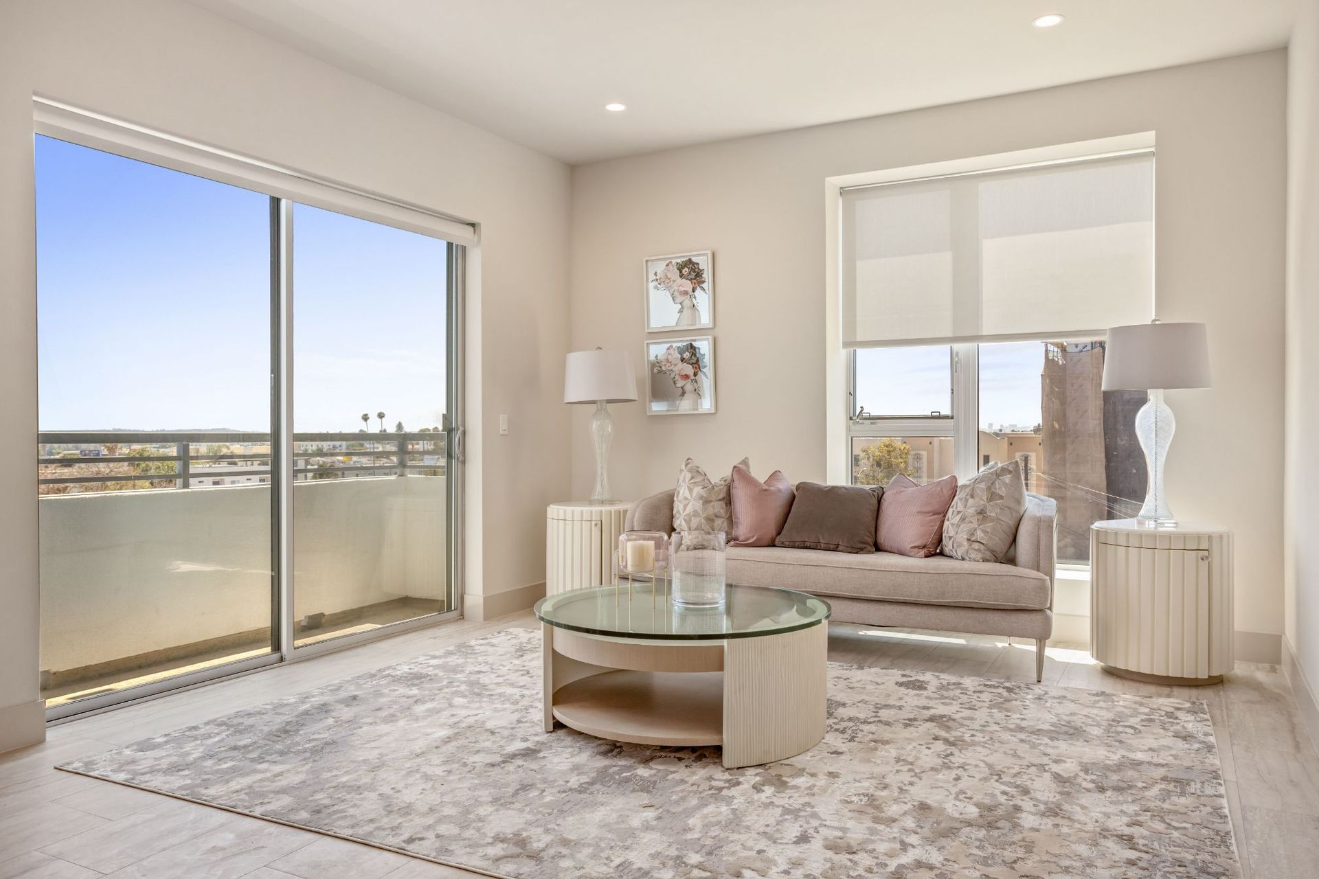 Living room with a beige sofa, rug, and coffee table near a sliding glass door and window.