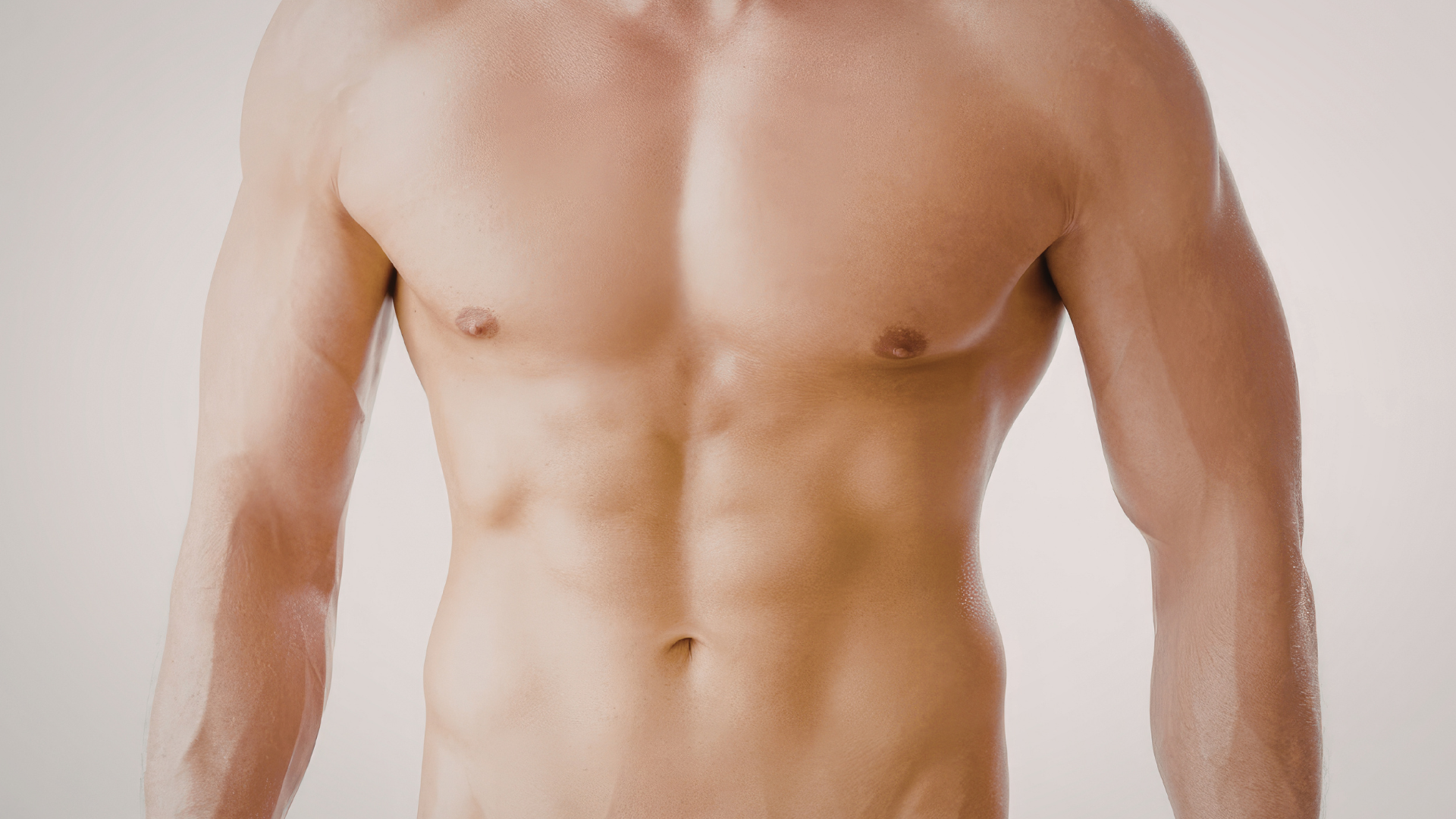 Torso of a muscular person against a plain light background